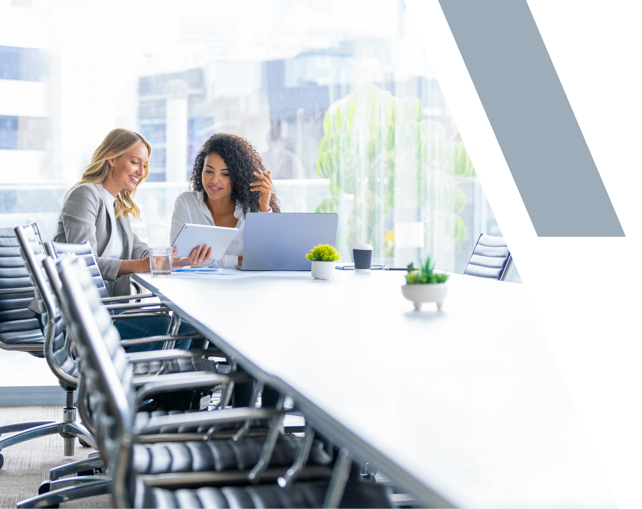 Two women discussing in a conference room